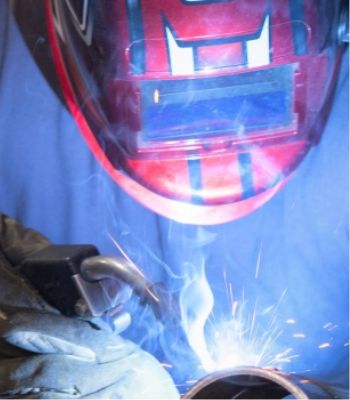 a man welding in red helmet